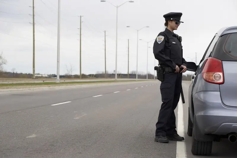 Female police officer standing - demonstrating height requirements for police careers