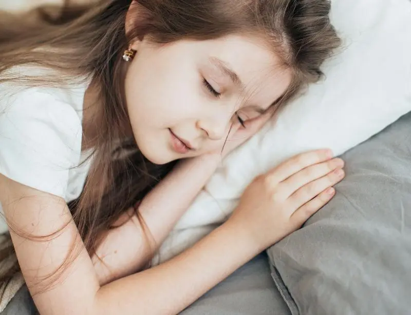 Teen girl in deep sleep - showing the importance of quality sleep for growth hormone release